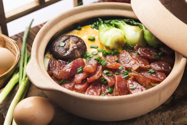 Cantonese style cooking of claypot rice with waxed meats